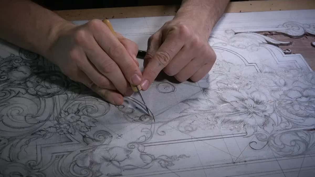 Two hands guiding the blade down the second side of an element, keeping its width even