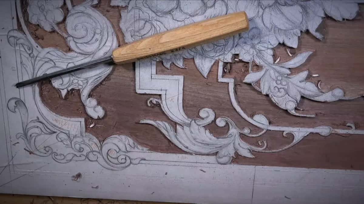Two tools laid out on the carving, nobody holding either