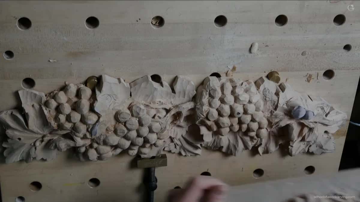 Whole panel from above with both grape clusters carved and the leaf section still waiting