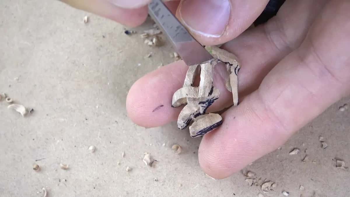 Chamfering with a straight blade, the whole piece lying across two fingers.