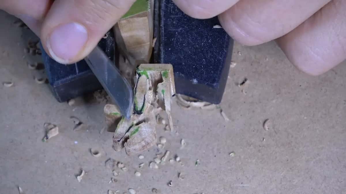 Flat blade squaring an upright face, marked green.