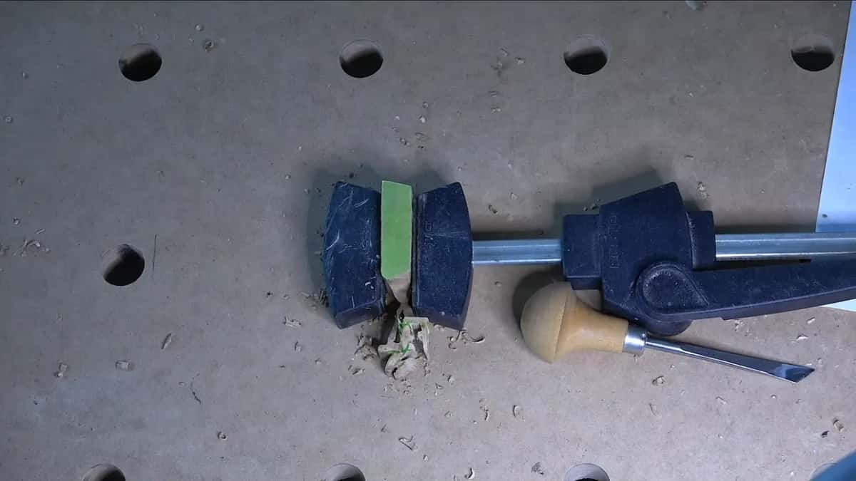 Clamped by its tab alone.