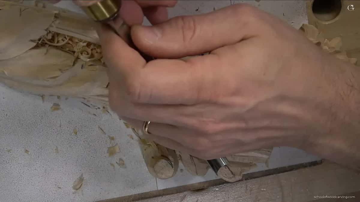 Knife starting the shell, working down toward the pencil mark.