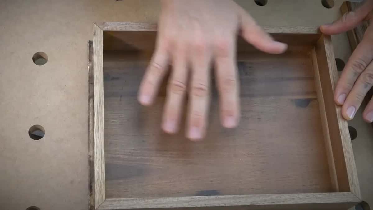 Inside of the acacia box before the lining went in, a thin divider running across the middle of it