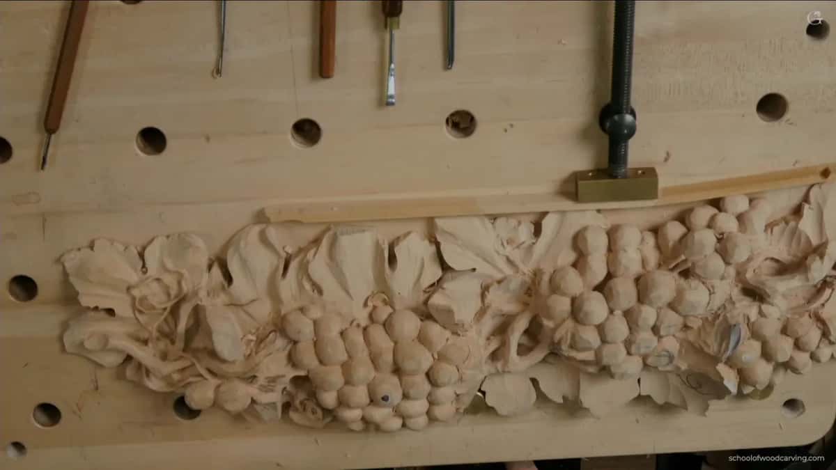 Whole carved run seen from above, every cluster finished and the vine weaving between them