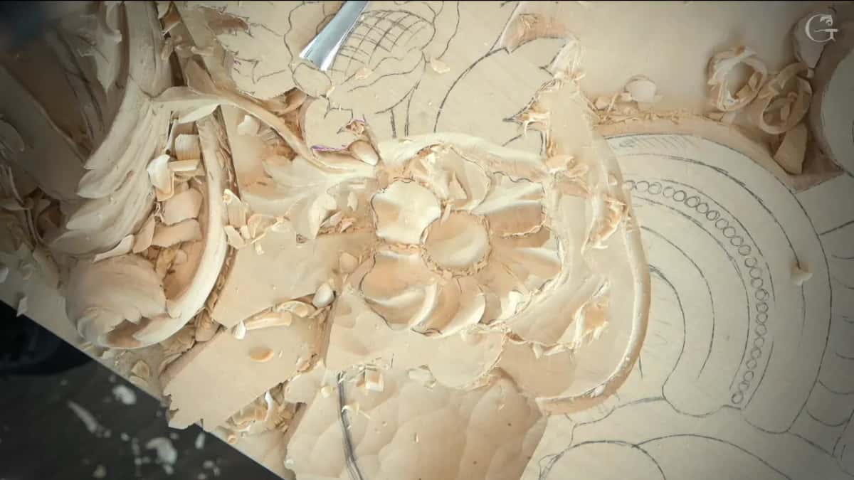 Carved rosette seen from directly above, petals open around the punched centre
