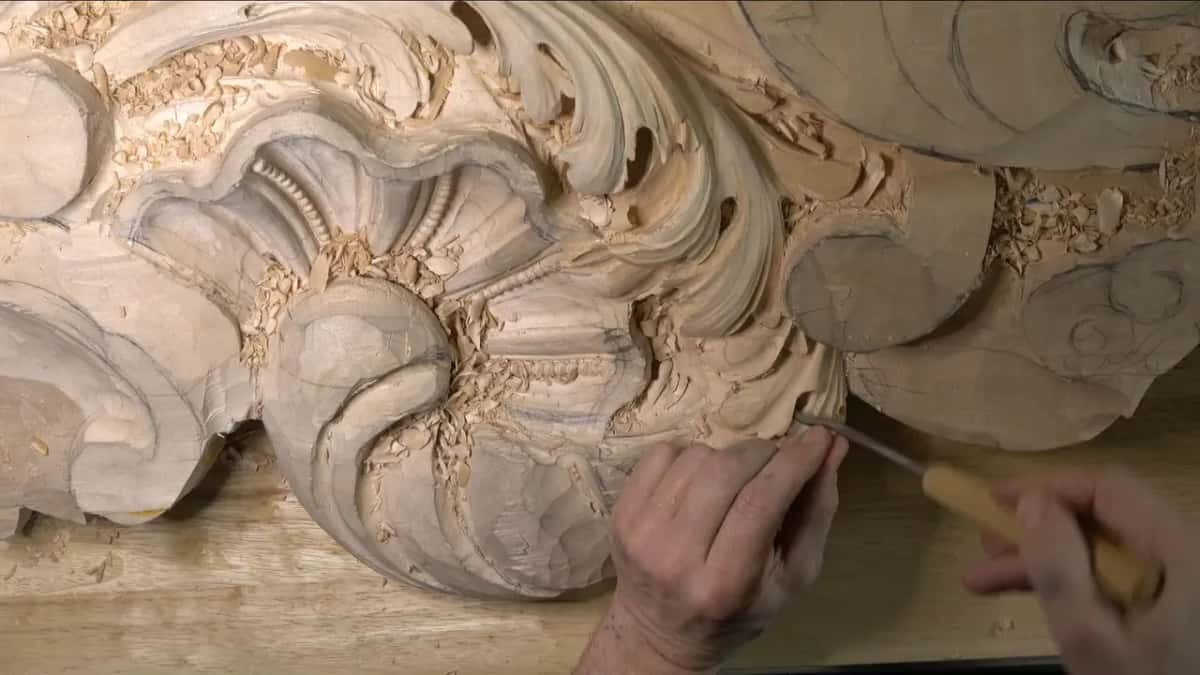A pale handle angled low as the edge goes under a lobe.