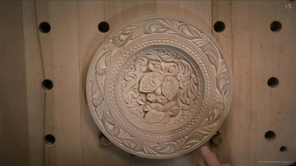 Seen from above, the bare plate shows two butterflies in its dish and curling leaves around the rim