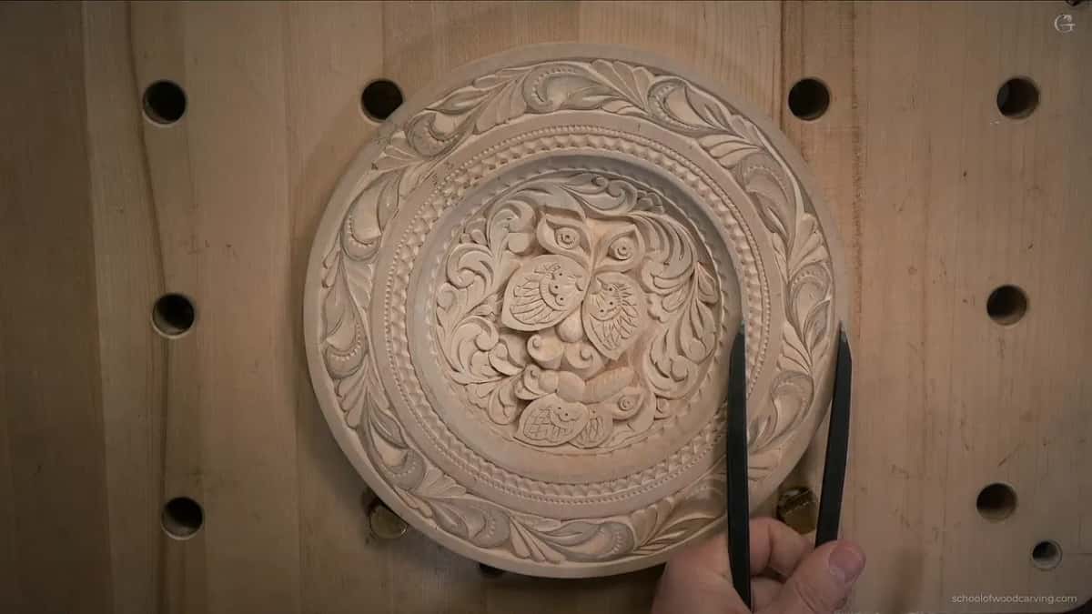 Caliper points reach the outer band of the finished plate from a hand at the bottom edge