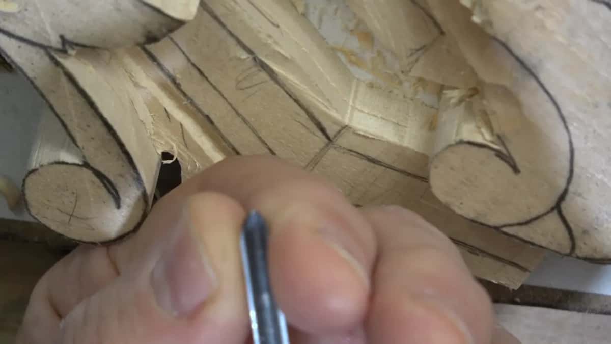Fingertip and a narrow blade at the end of that run, where a wider tool has nowhere at all to go.