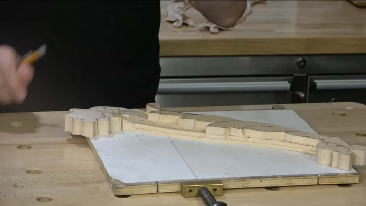 Pencil raised above the piece.