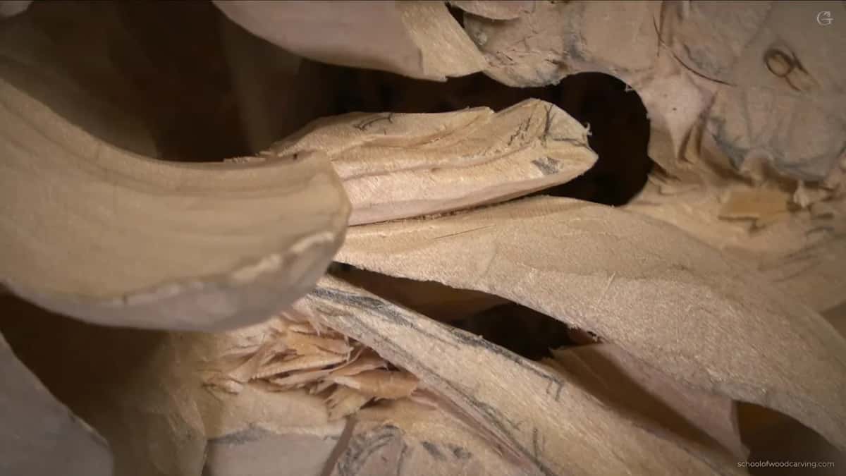 Dark opening behind a carved leaf on the Grinling Gibbons panel, the walnut showing through where the wood was taken away