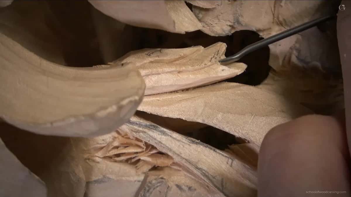 Tiny bent tool going into the dark opening