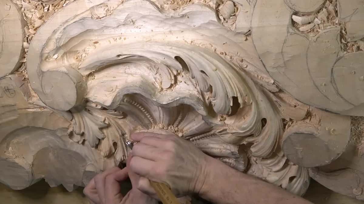 Both hands on a pale handle.