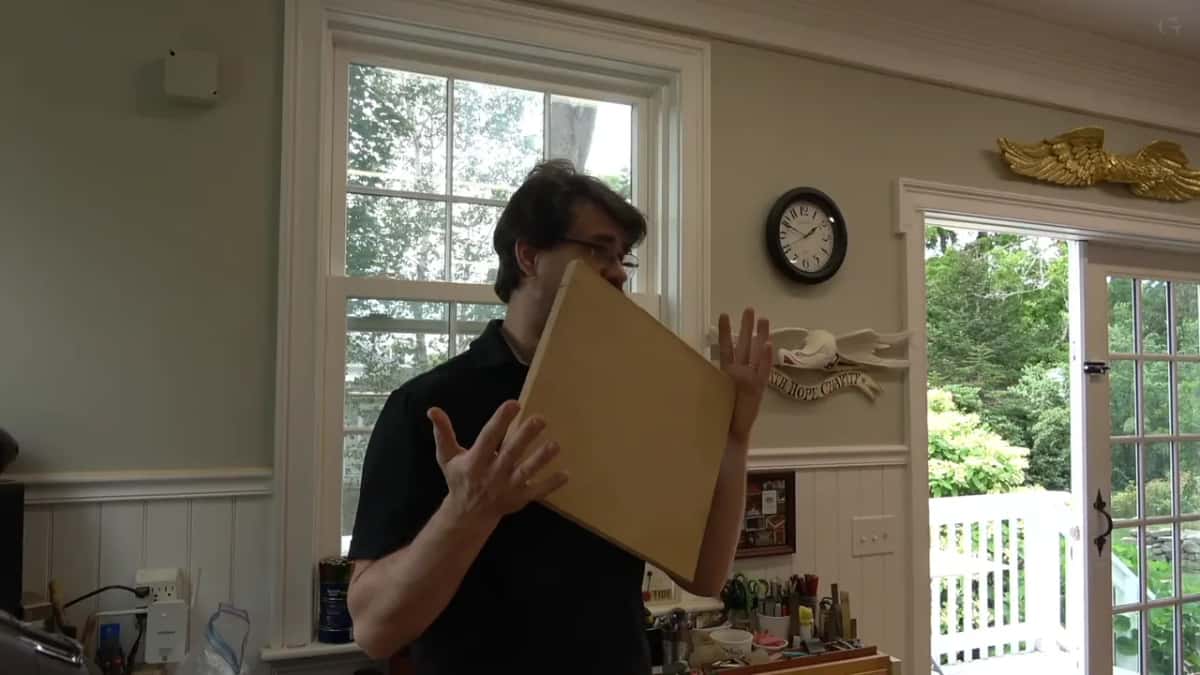 Alexander holding the MDF backer board up in the studio