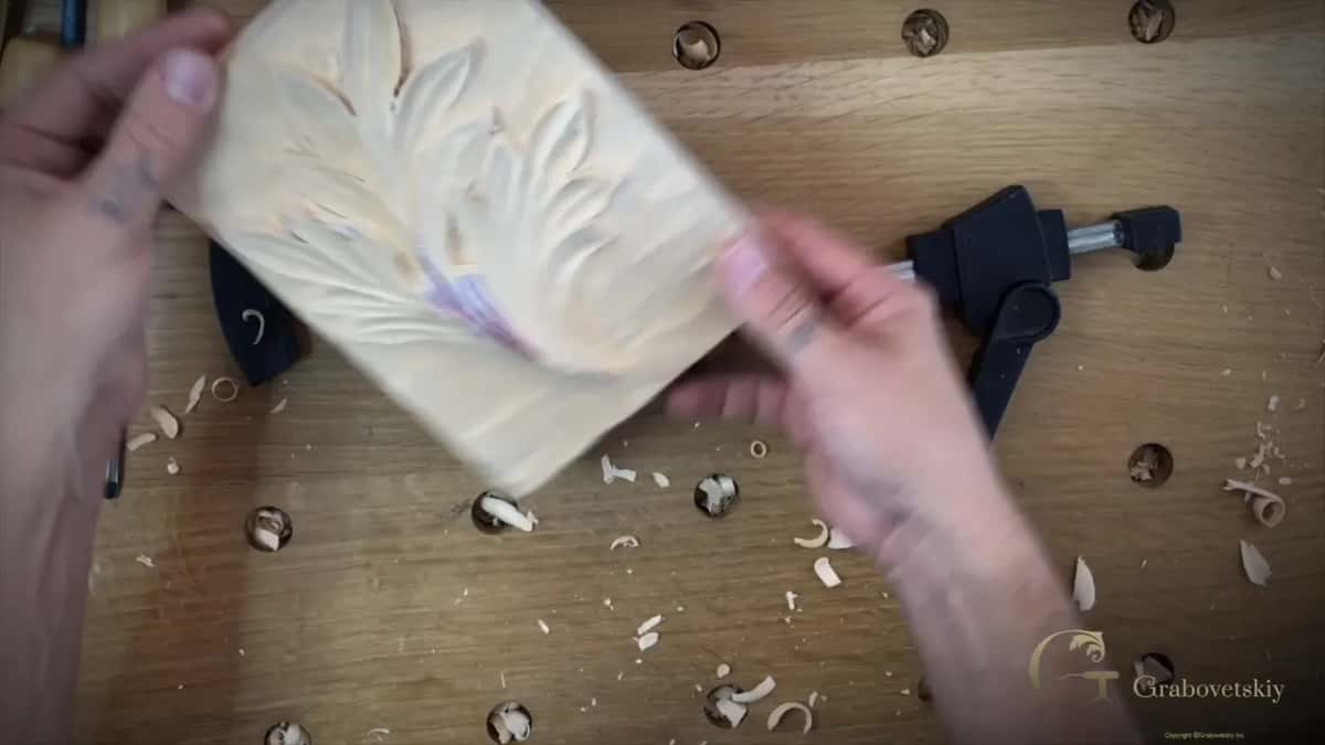 Both hands hold the finished block up to the light at the end of the workshop.