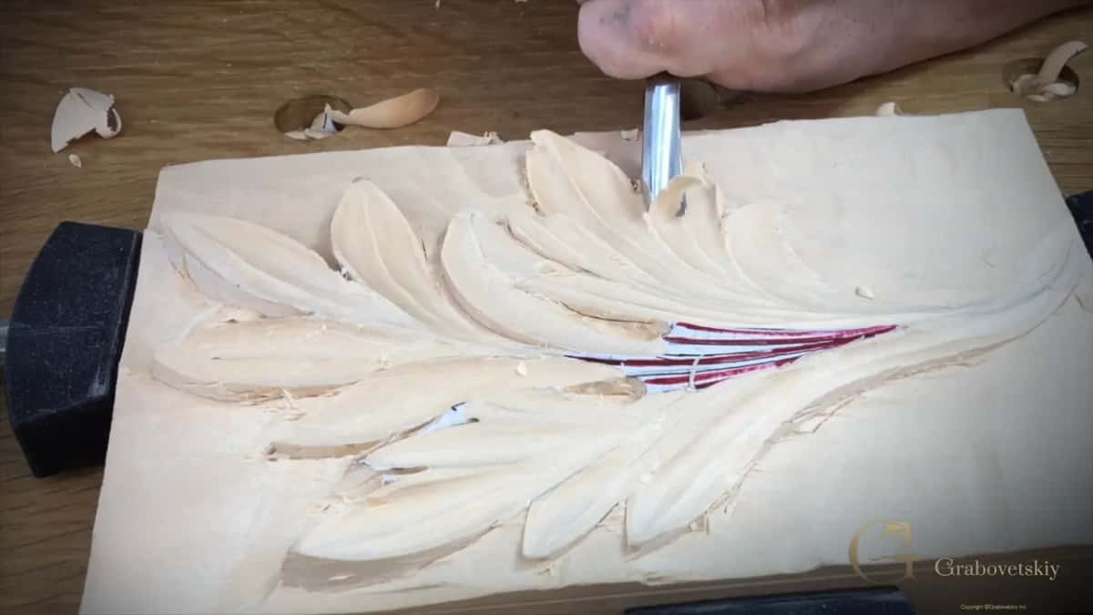 The handle turning in the hand as the blade travels, which is what makes the cut slice instead of push.