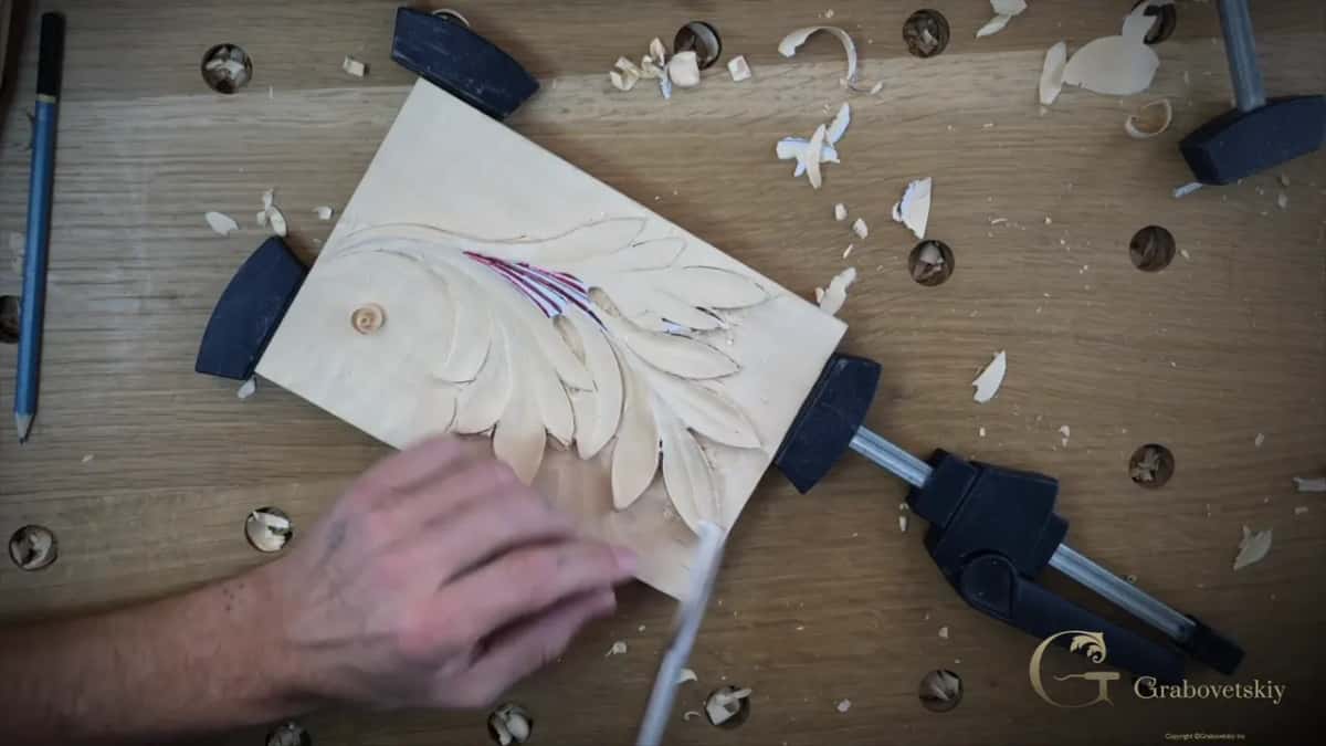 The block clamped at a steep angle so the grain runs the right way, chips thrown across the whole bench.