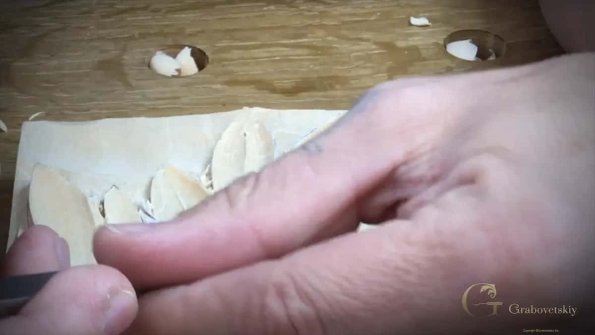 A thumb steadies the blade while it comes back over the same hollow from the other direction.