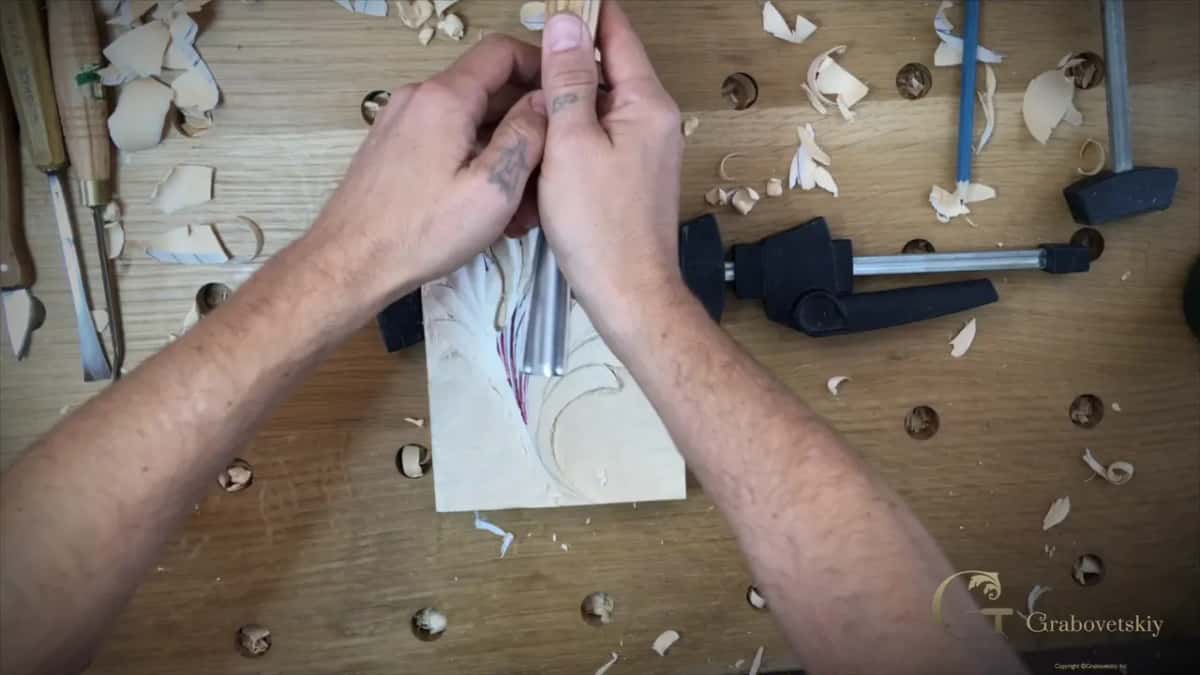 Both forearms flat on the bench, hands locked together on the tool.