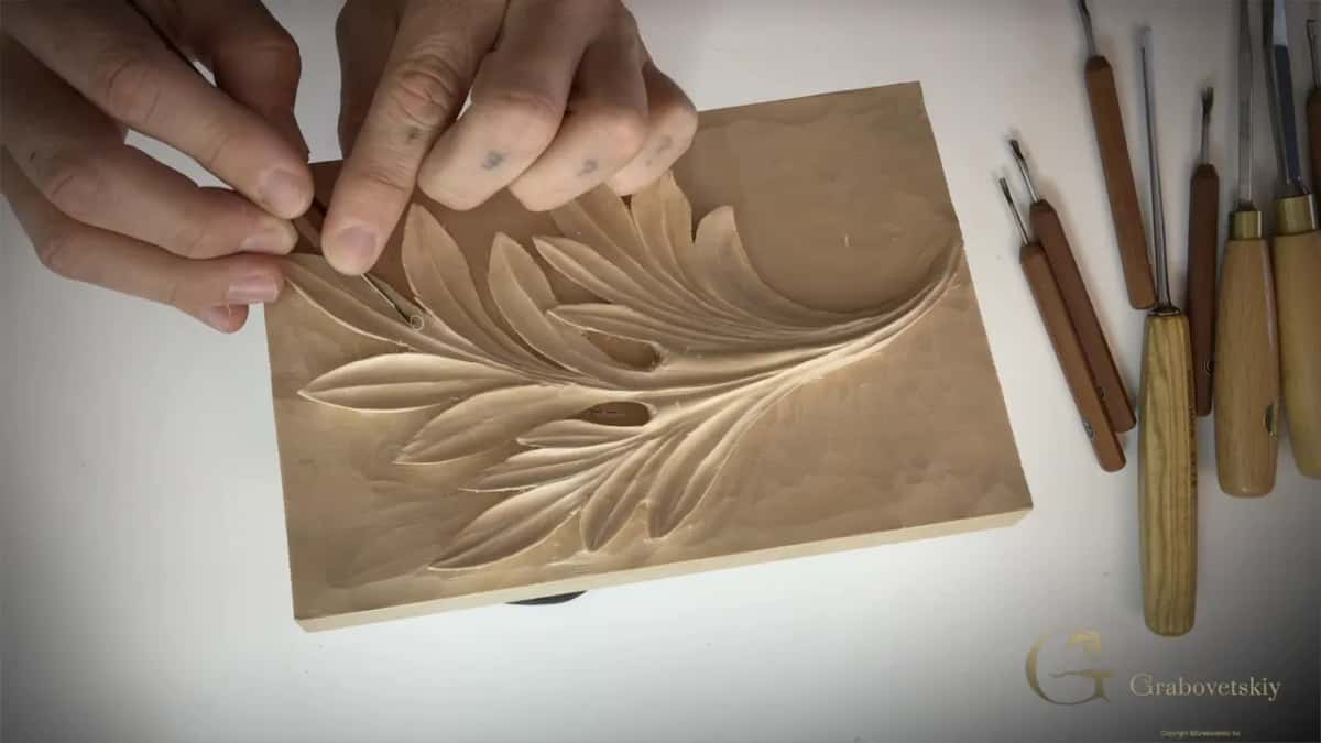 Hands over the panel with the small gouges laid out to the right.