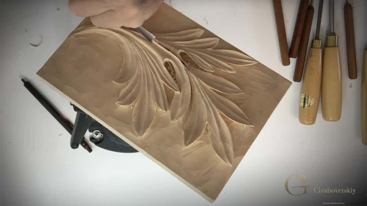 The cleaned leaf with a pen and several gouges lying on the bench around it.