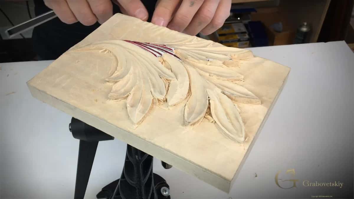 Both hands at the top edge.