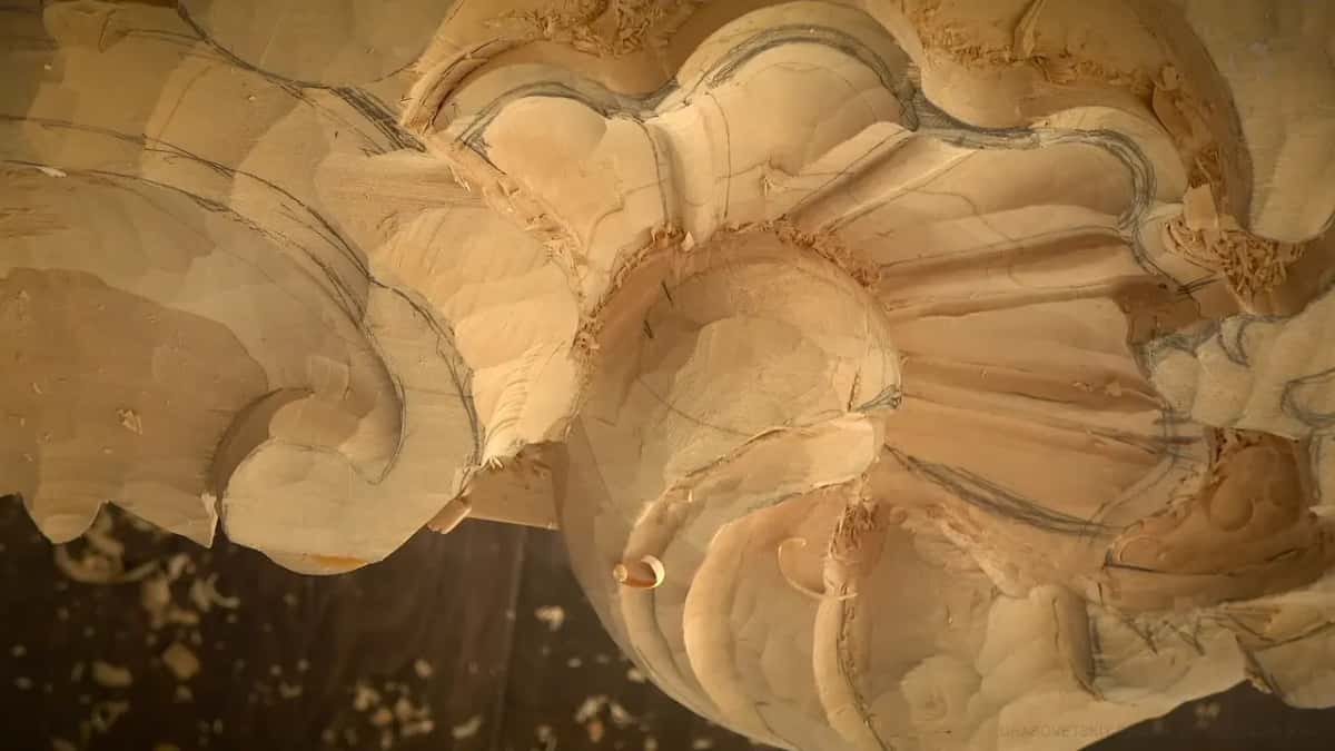 Pencil lines follow every rib of the half carved shell, chips lying in the hollows before any beads.