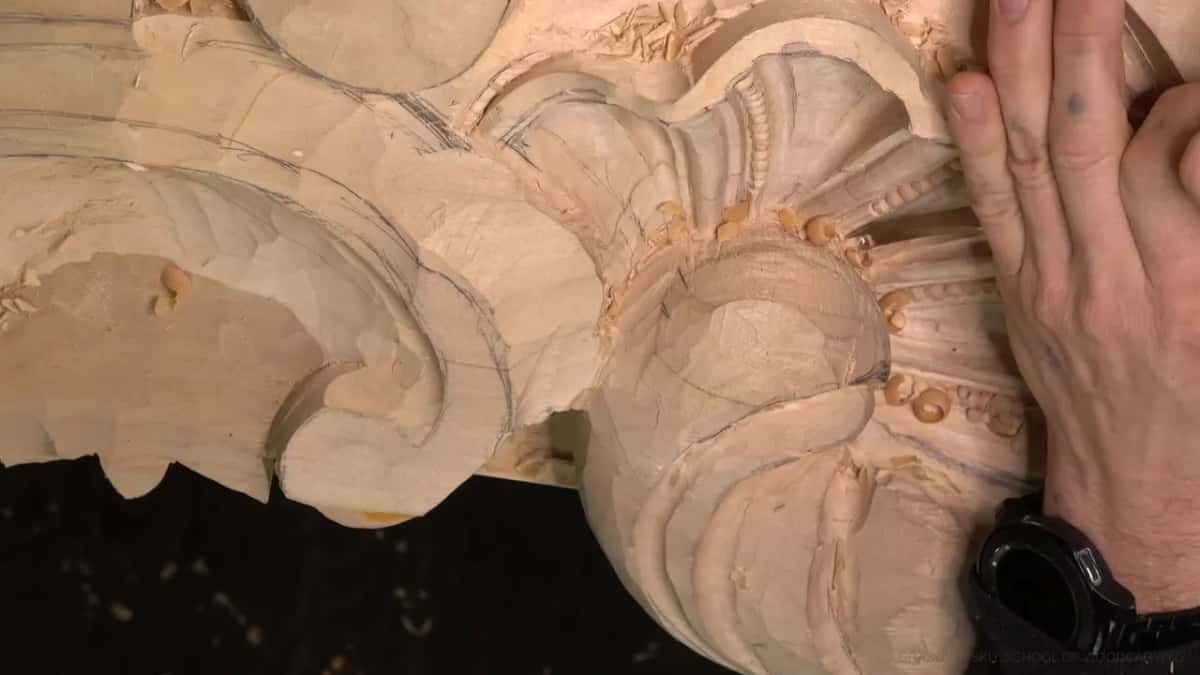 An open hand steadies the shell.