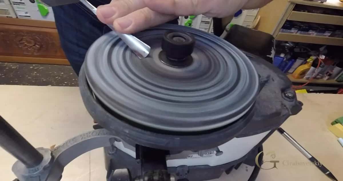 Paste stick pressed onto the dark wheel while it spins