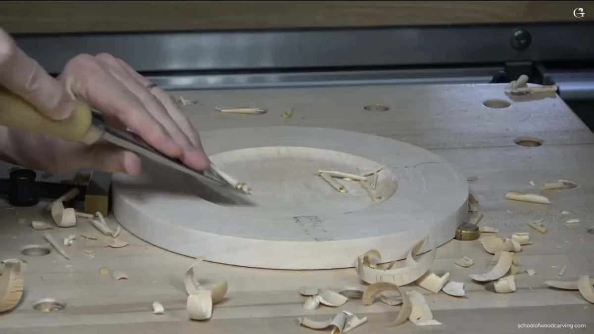 A wide, almost flat gouge smooths the floor.