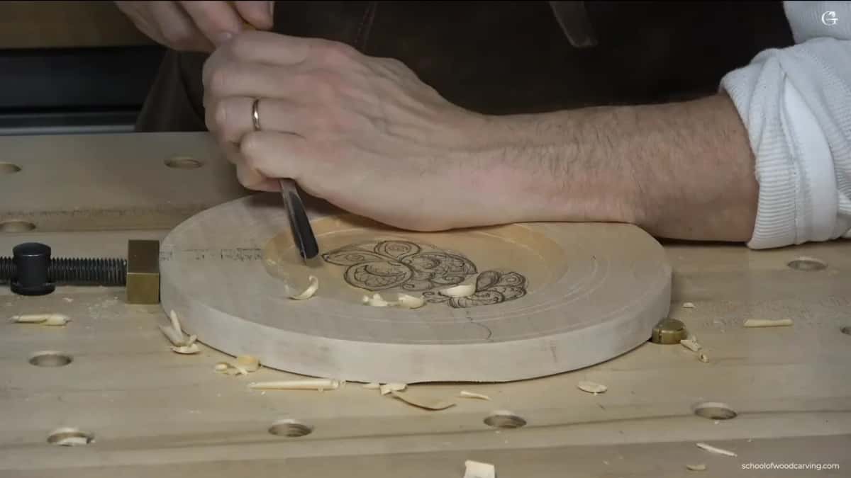 A number 9 gouge steps around the drawing, held nearly upright.