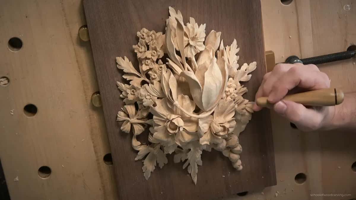 Knife handle in hand, tip resting on a petal at the right