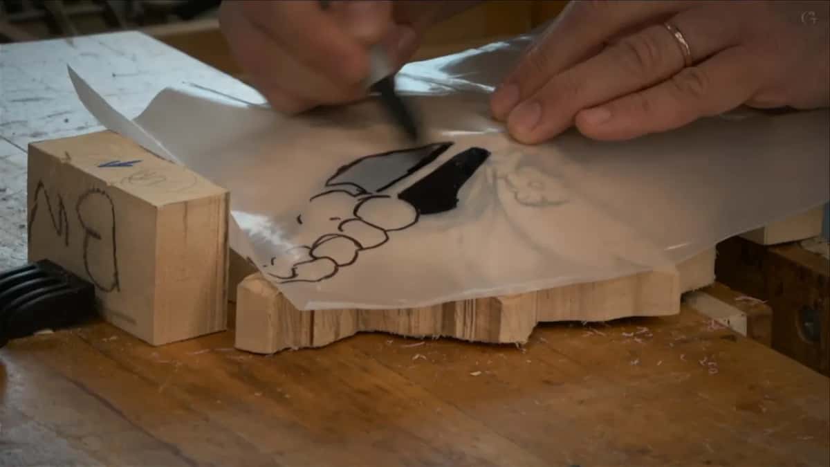 Clear plastic laid over the blank, the design drawn on it in black marker with two areas filled solid black