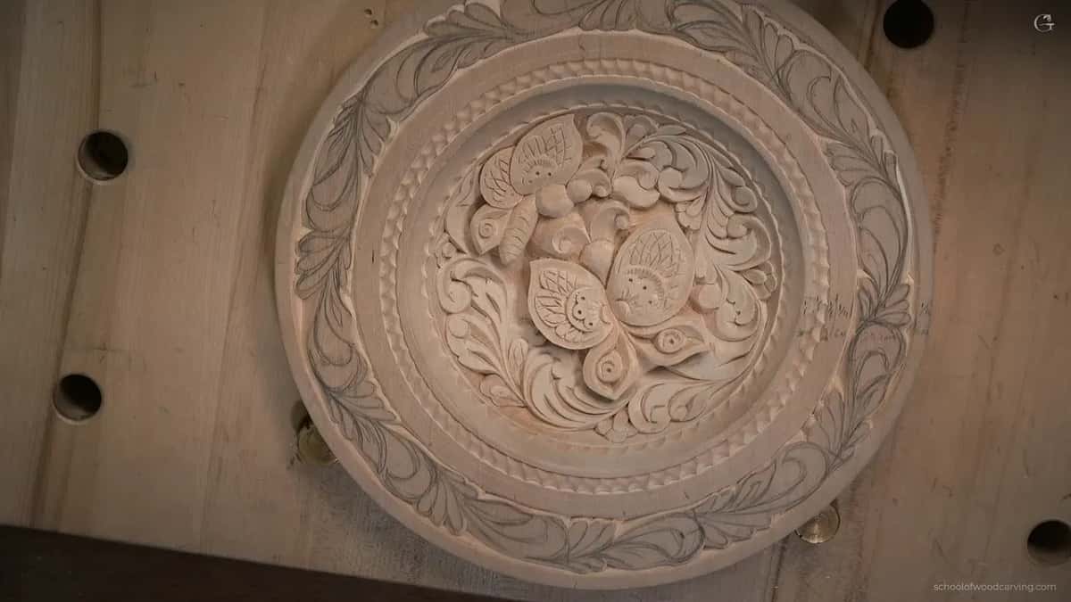 From overhead, the plate rests on the bench with pencil leaves around its rim and two butterflies in the middle