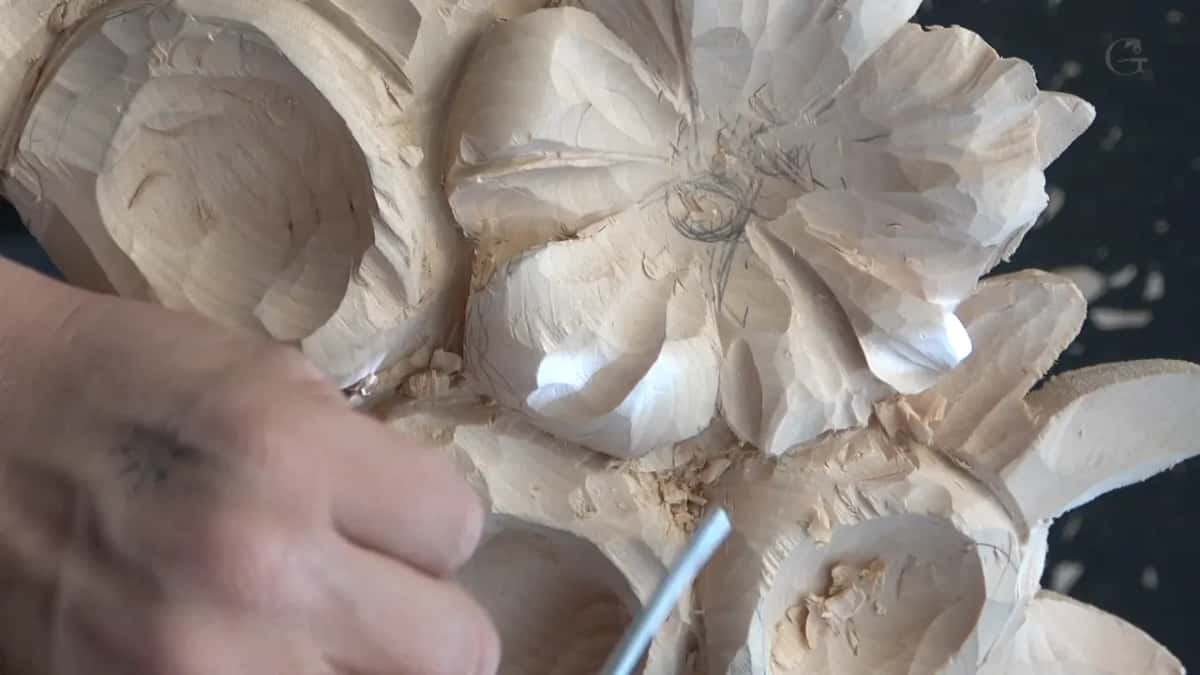 Round shanked tool laid almost flat to take excess from beneath a petal, the pencilled centre still readable above