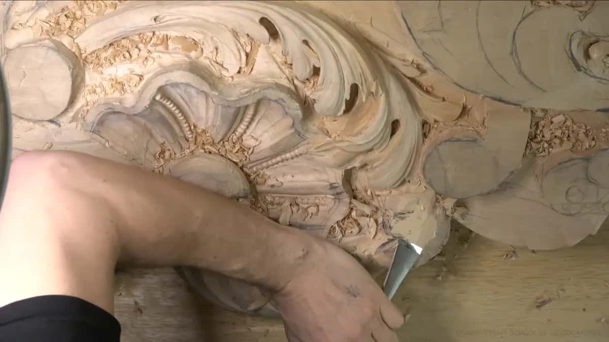 Wide flat gouge held low near the bottom lobe.
