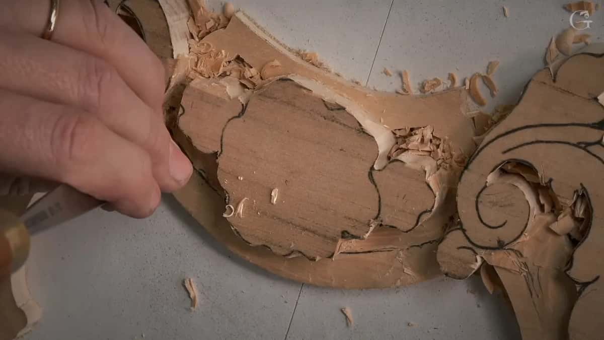 Hand resting on the levelled ground beside the drawn shapes