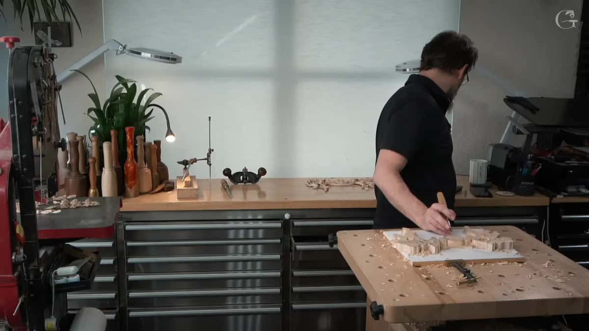 Marking the panel out at the bench with the router plane waiting on the counter behind him