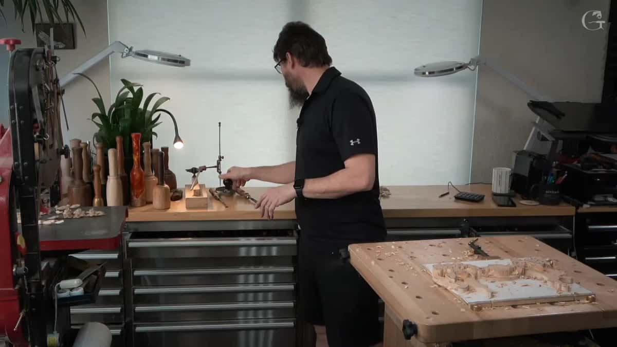 Panel clamped on the bench while the measuring arm waits on the counter behind