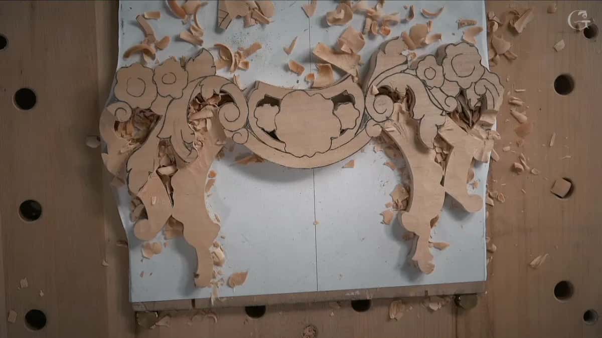 Both halves of the panel with their ground opened, flowers still solid, shavings scattered right across the paper underneath