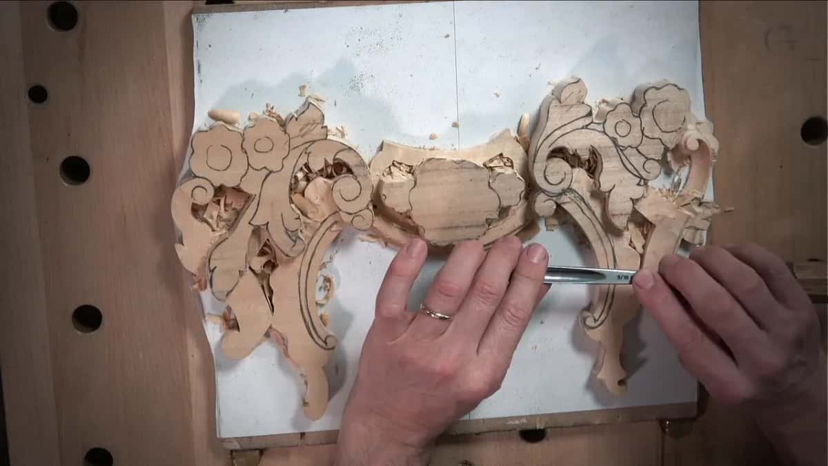 Gouge number nine, ten millimetres wide, following the drawn outline of the volute on one side only