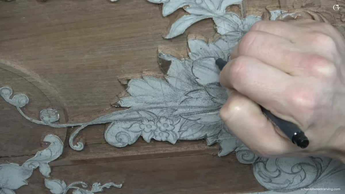 A fist grips the marker while the drawn flower waits underneath.