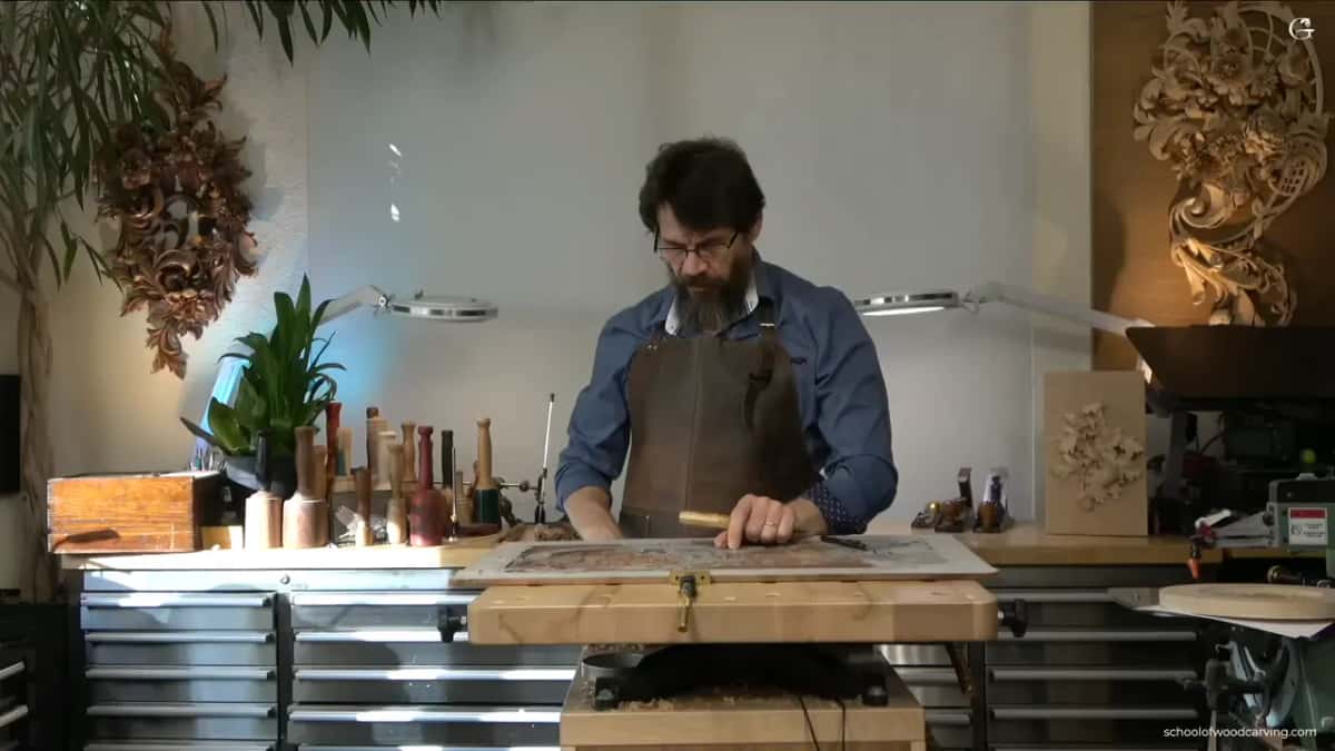Bench, lamps, jars of tools, and one man working.