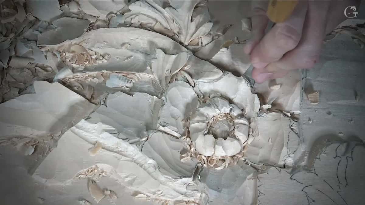 Petals around the middle, a hand with a yellow handle at the top of the frame