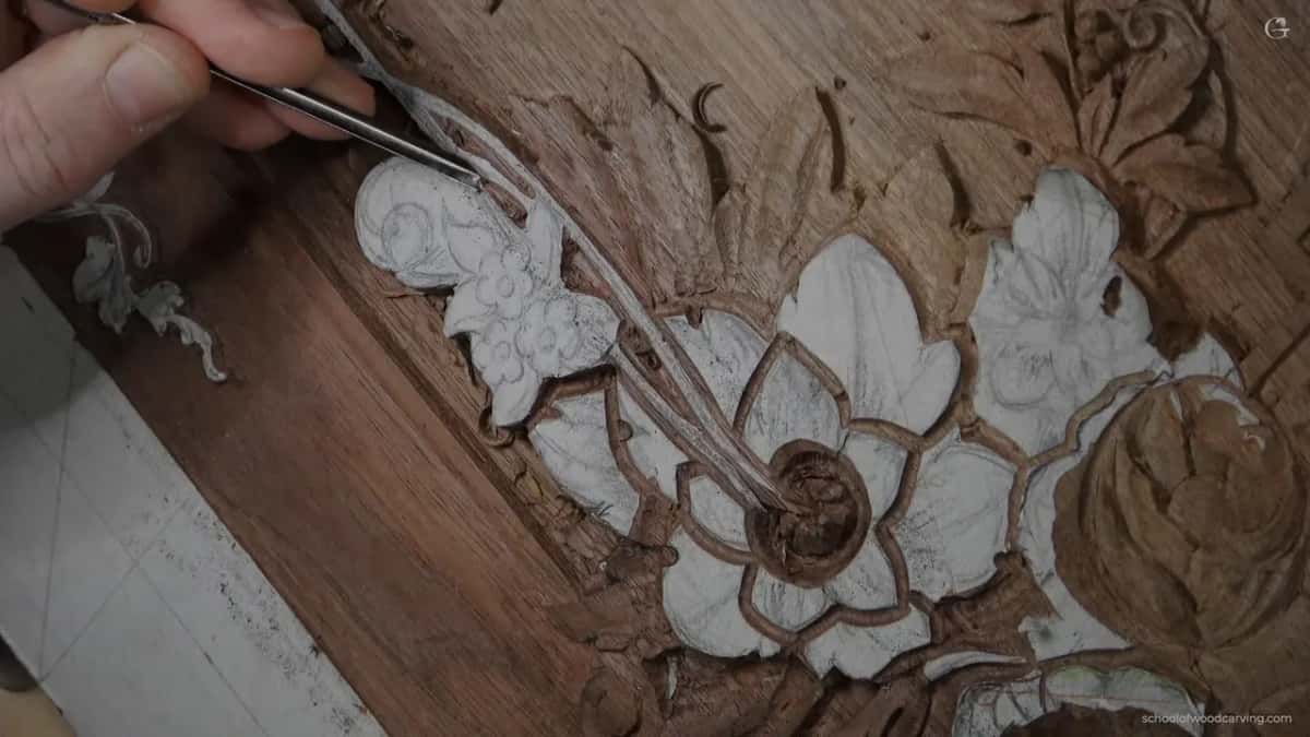 Hand with a veiner on the scroll, nothing removed yet.