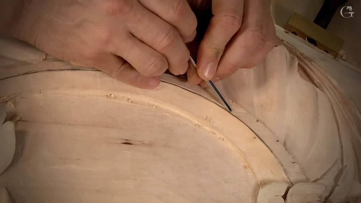 Knuckles close together as two hands guide the tool around the curve