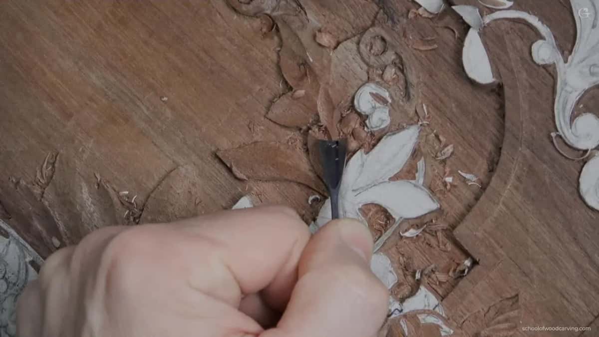 A broad flat blade in a closed fist, hollowing the middle of a leaf that had looked lifeless.