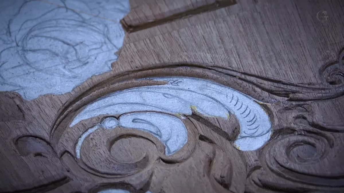 Completed scroll with its paper intact, moldings running away behind it in clean carved lines