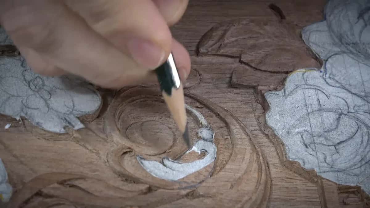 Sharp pencil point resting on the carved spiral